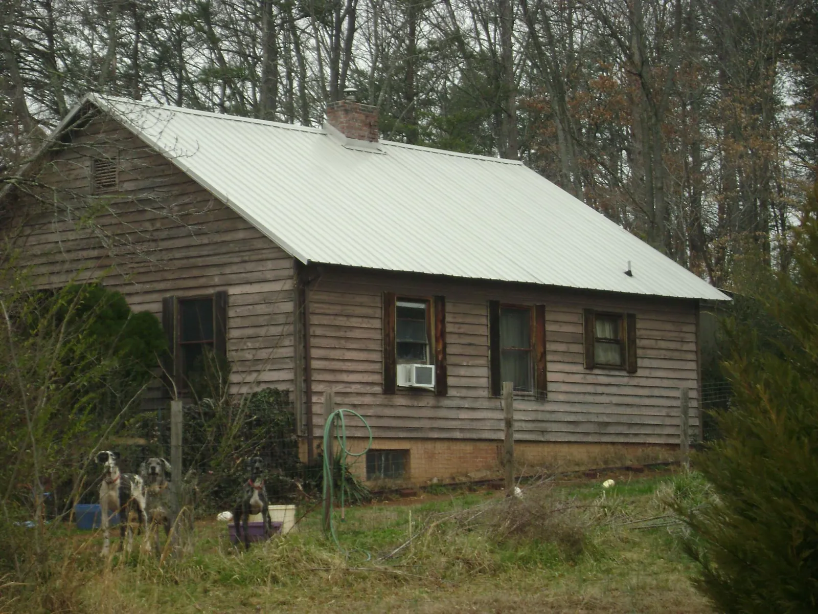 White metal roof on an old wood sided farmhouse, from a Metal Roof Installation job in Ulysses