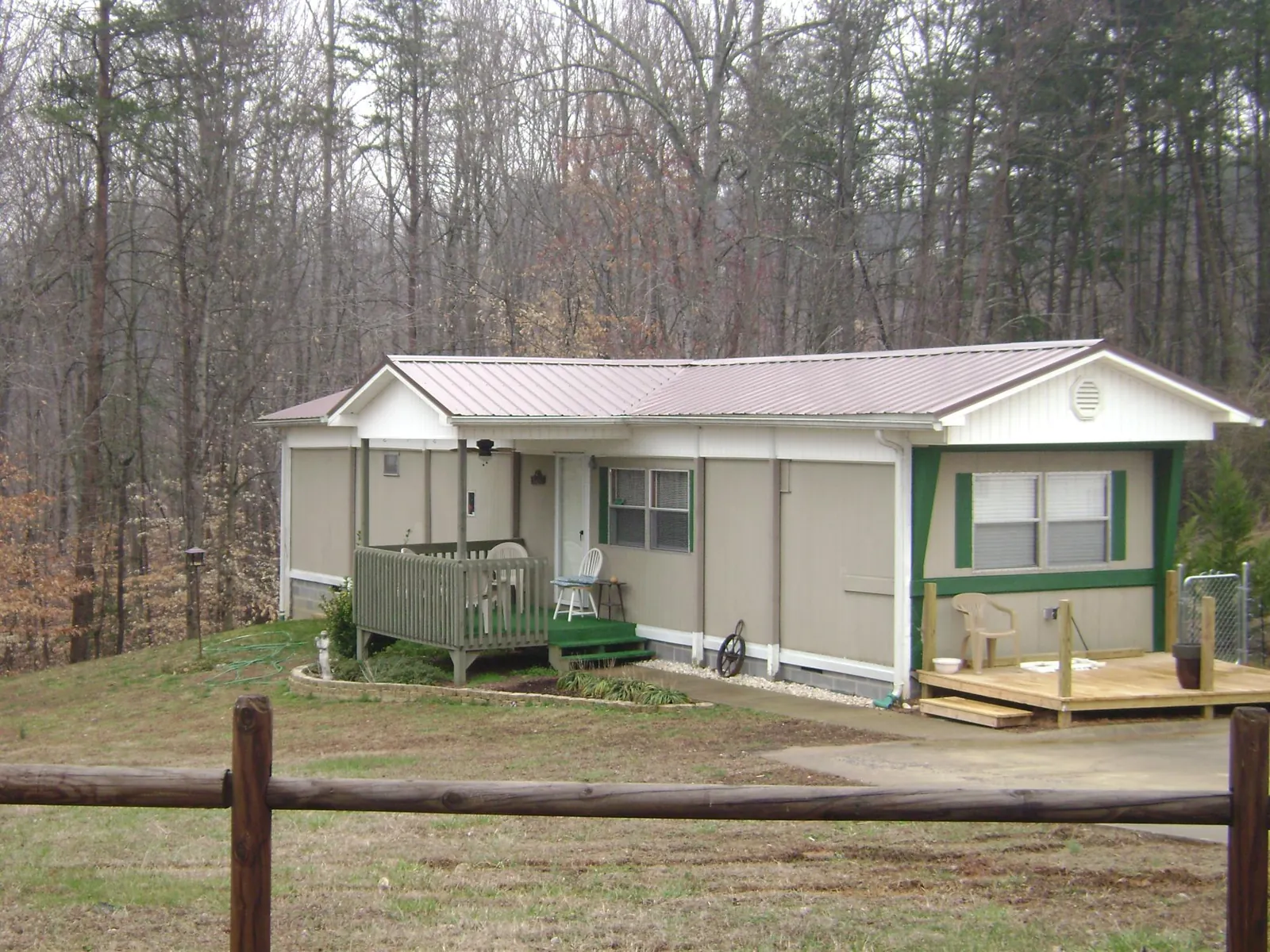 Mauve metal roof on a manufactured home with a new front deck in Ulysses